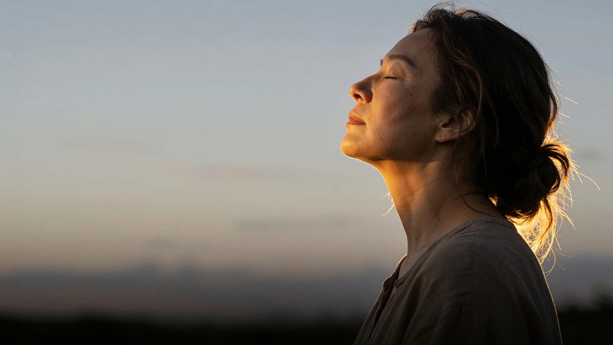 A woman with her face turned up to the sun